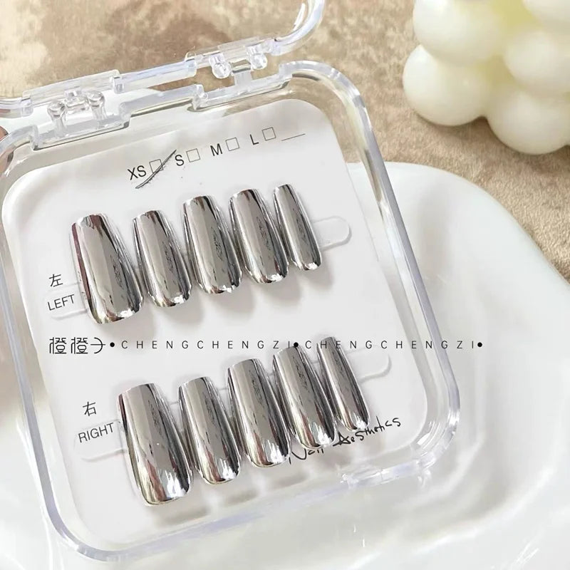 Silver metallic press-on nails in a case