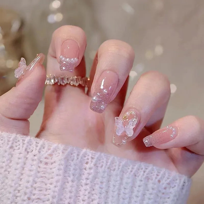 Pink decorated nails shown on a hand