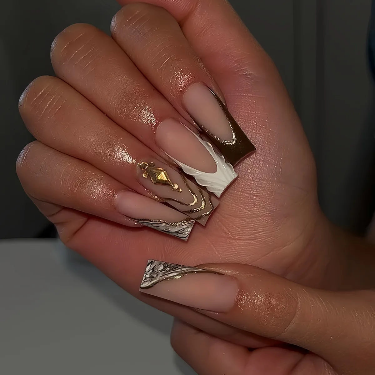 Long decorated nail designs shown on hands