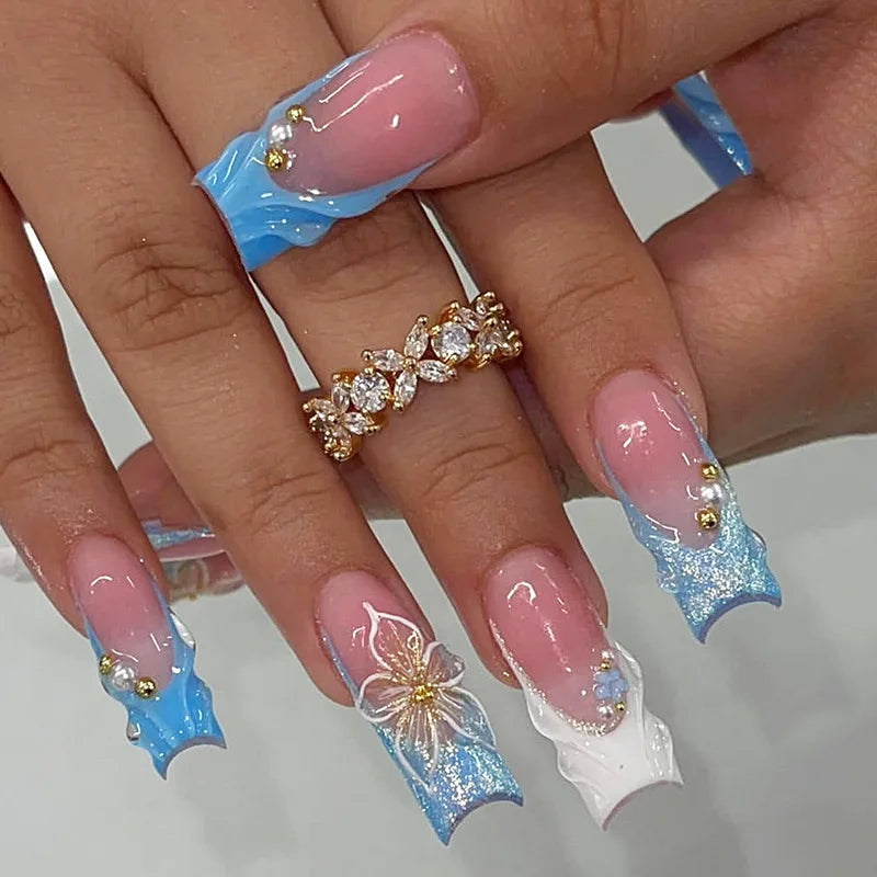 Long decorated nails with raised embellishments shown on hands