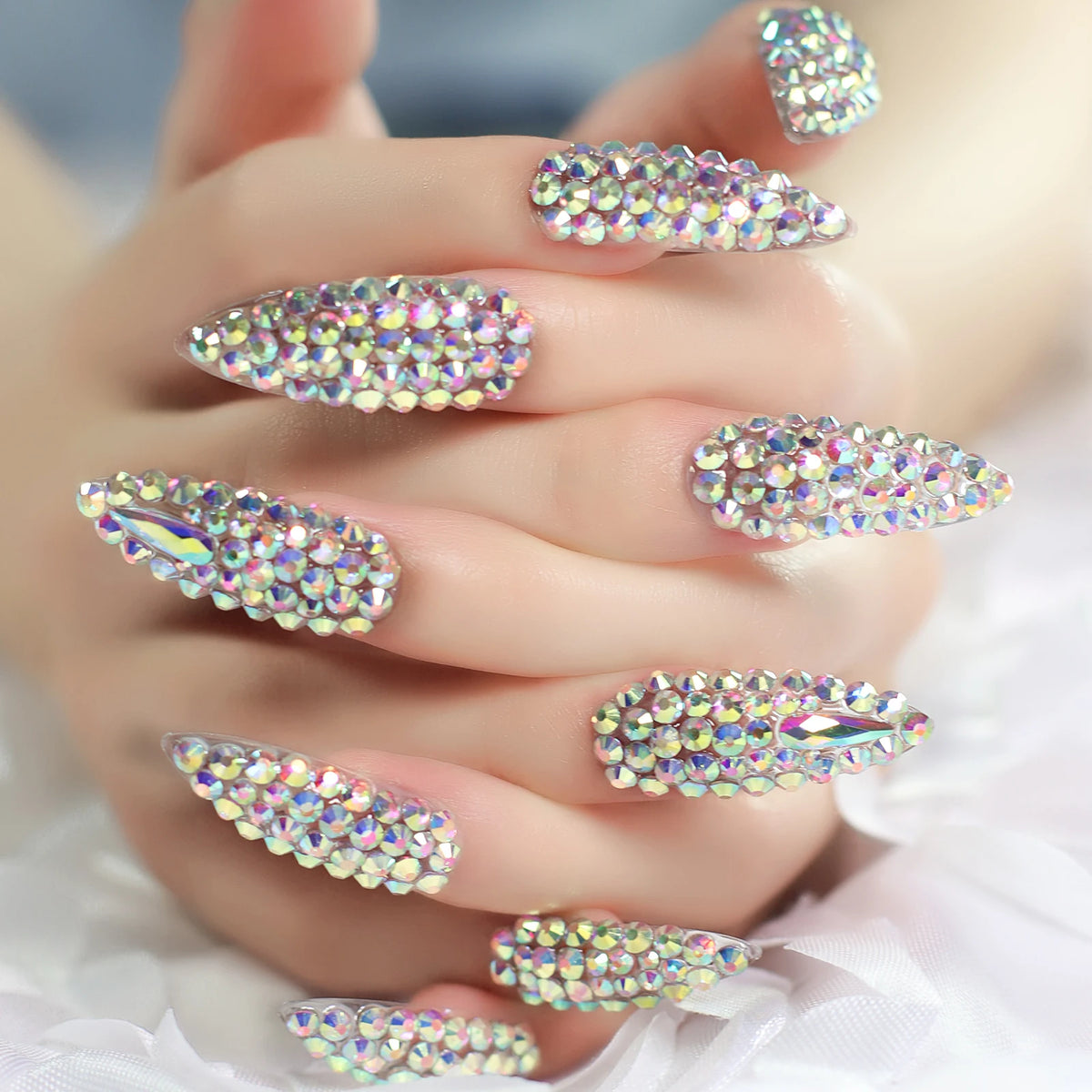 Rhinestone-decorated nail designs shown on hands