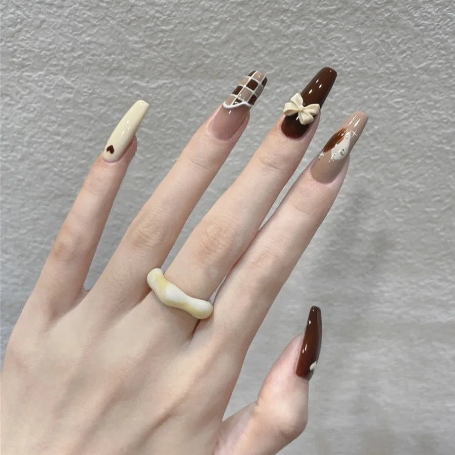 Decorated press-on nail designs shown on hands