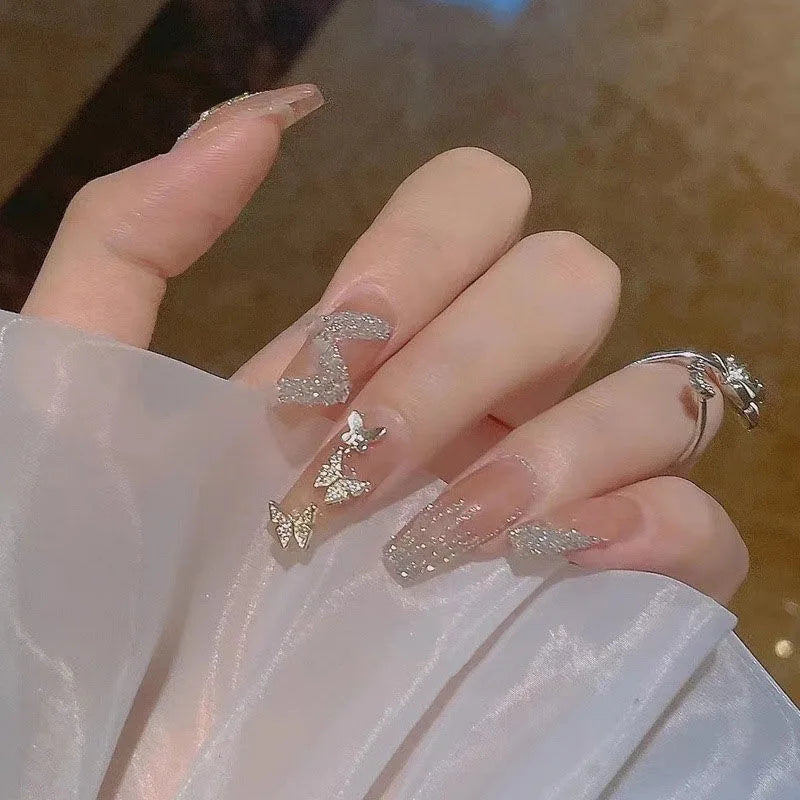 Decorated translucent nails shown on hands