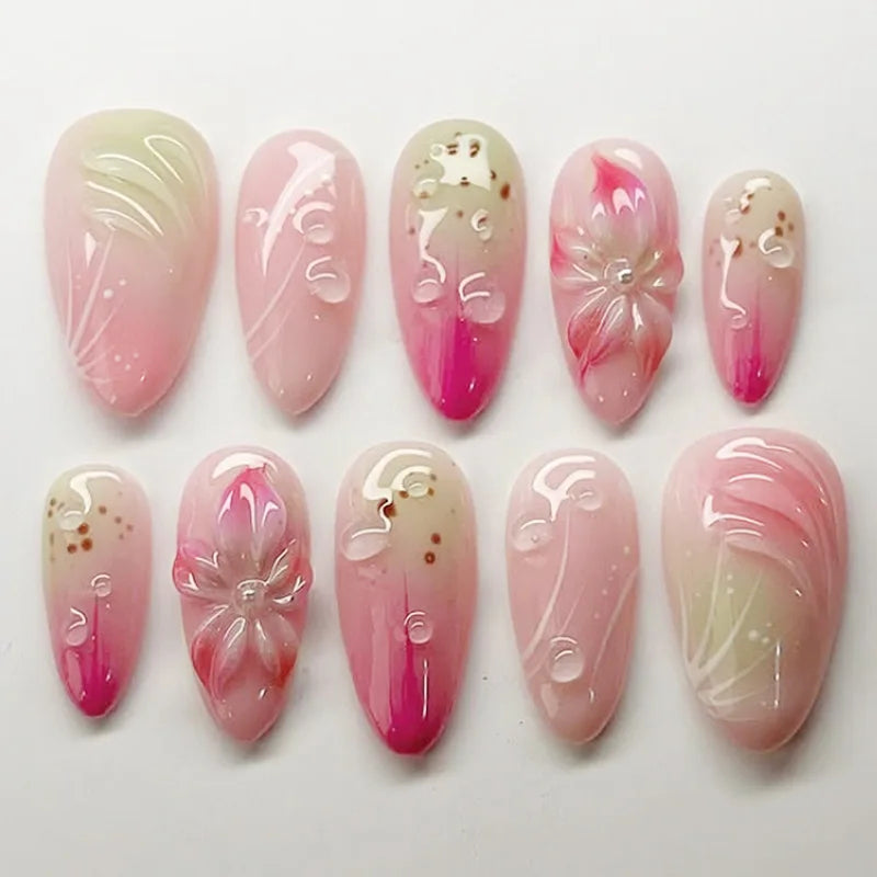 Pink floral press-on nails arranged in rows