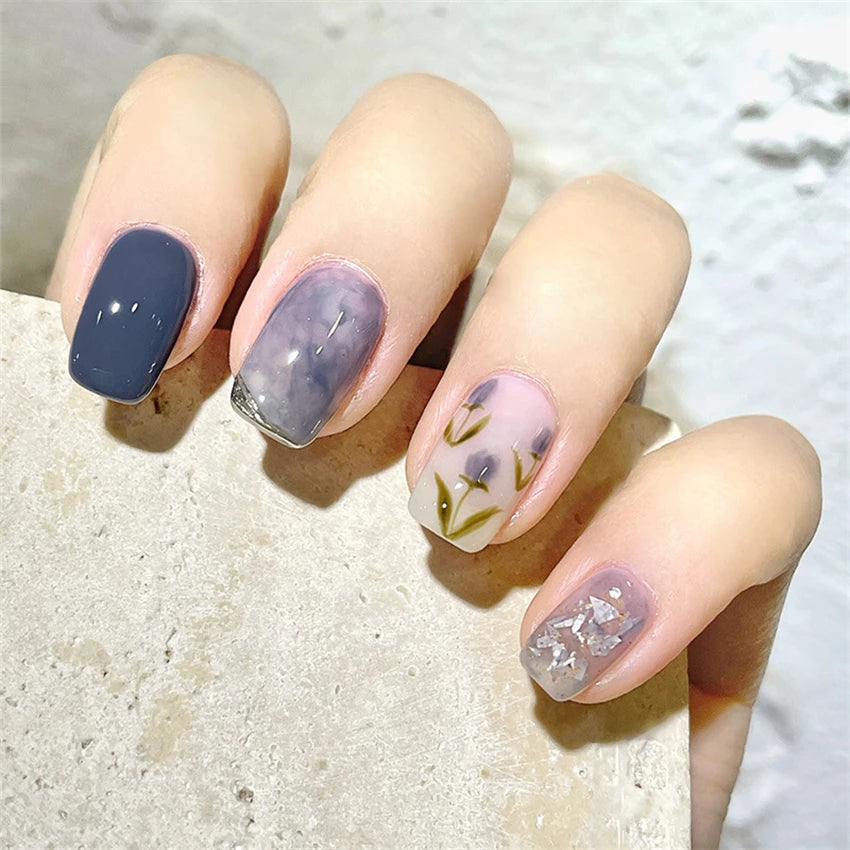 Decorated nail designs shown on hands