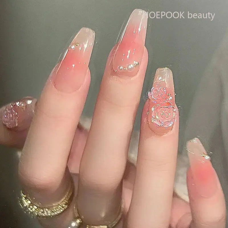Long decorative nail designs with raised accents shown on hands