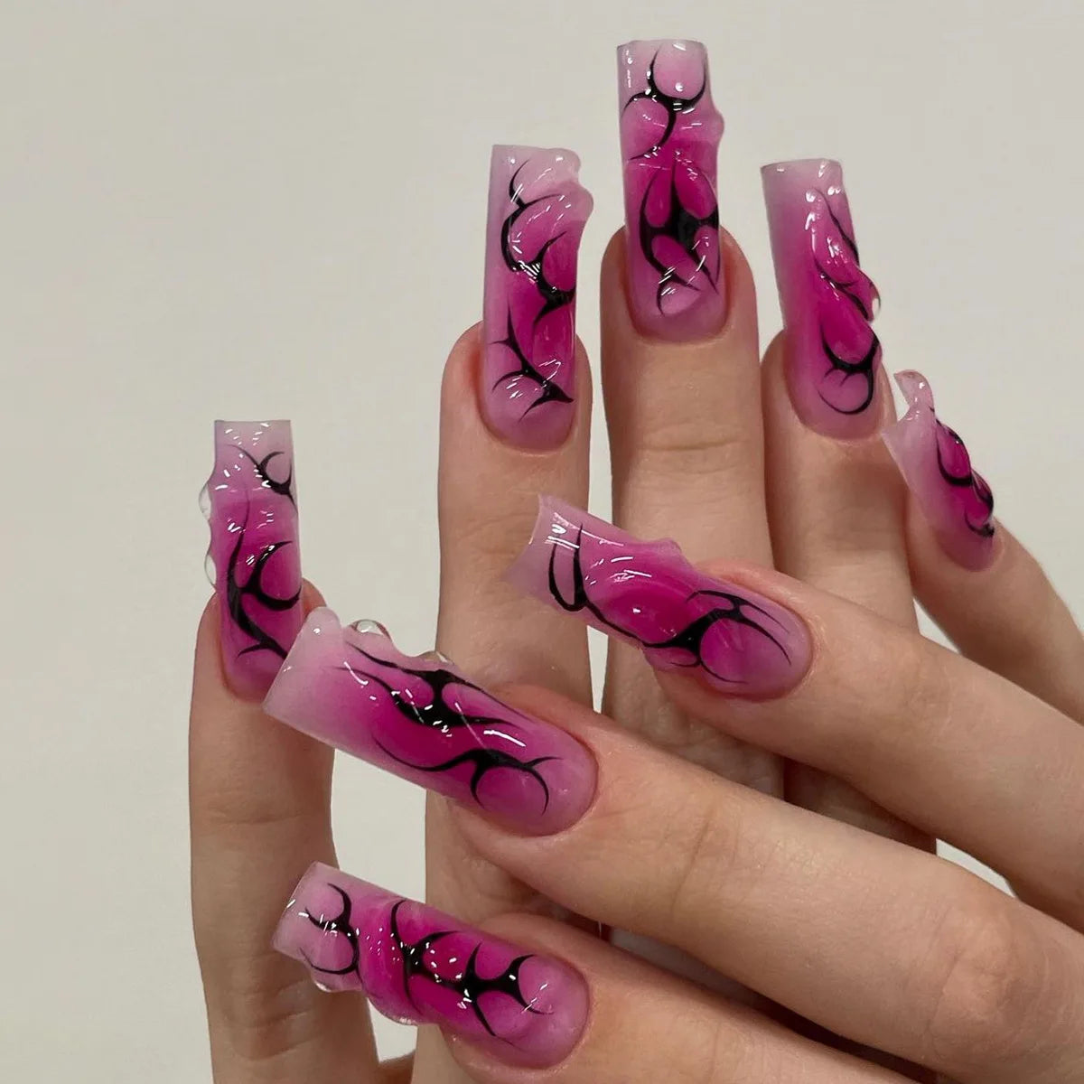Long decorated nail designs shown on hands