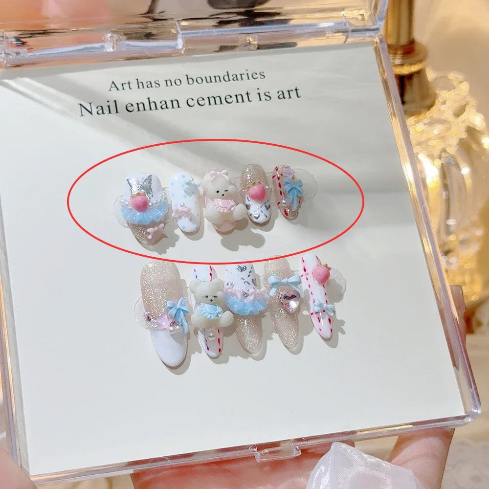 Decorated press-on nail sets with raised embellishments on display cards