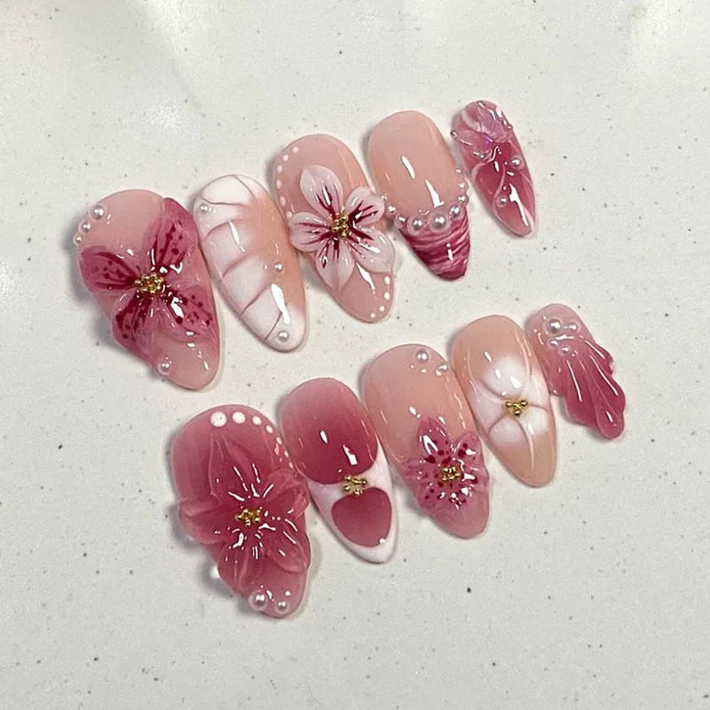 Pink floral press-on nails arranged in two rows