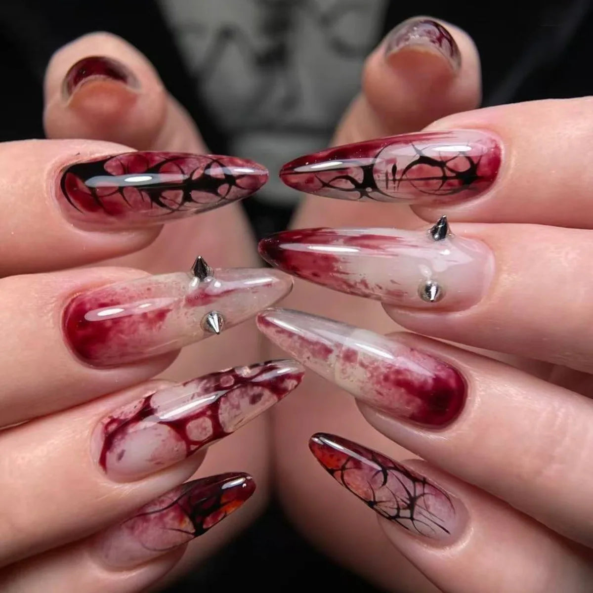 Long decorated nails shown on hands