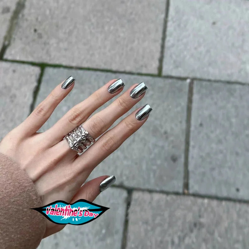 Silver metallic nails shown on hands