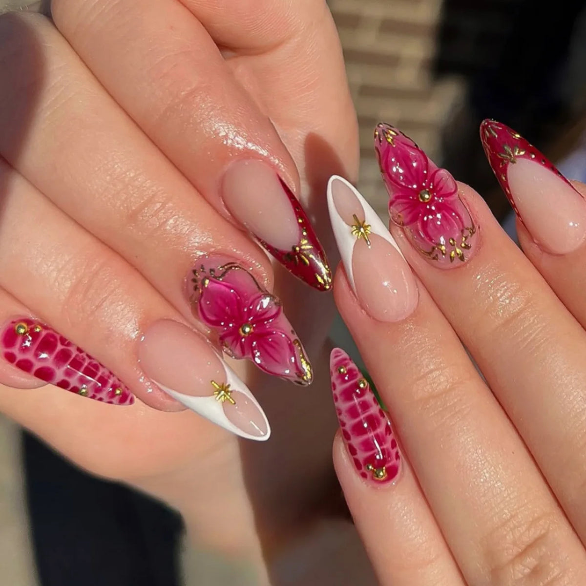 Decorated floral nails shown on hands