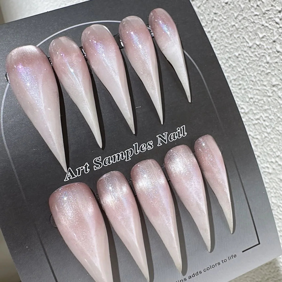 Decorated pointed press-on nails arranged in two rows